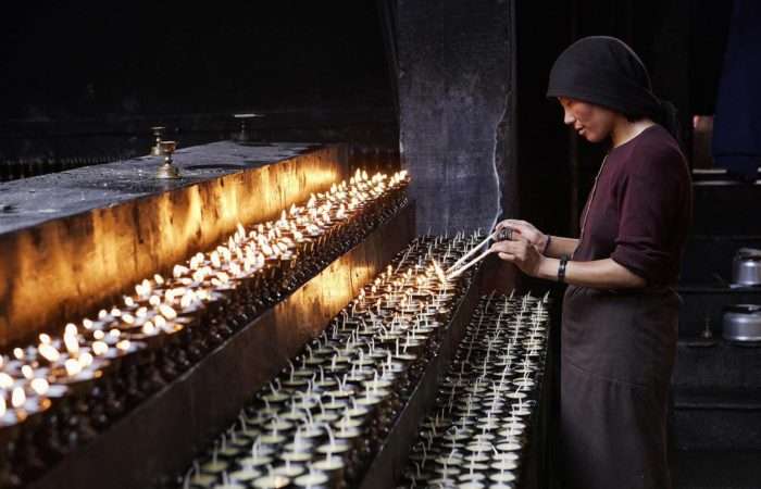 Girl praying at an ancient temple